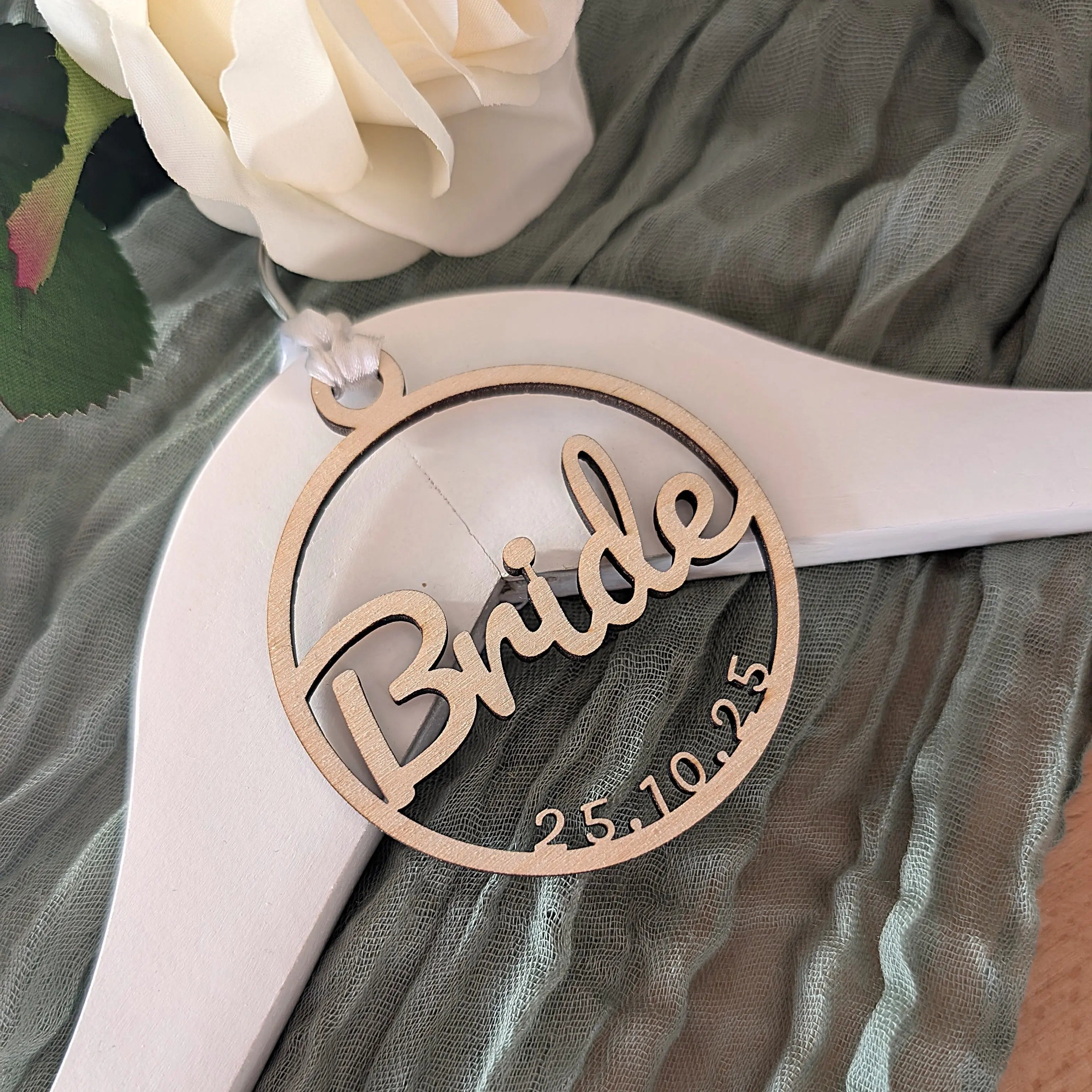 Wooden 'Bride' ornament with date on a sheer fabric background