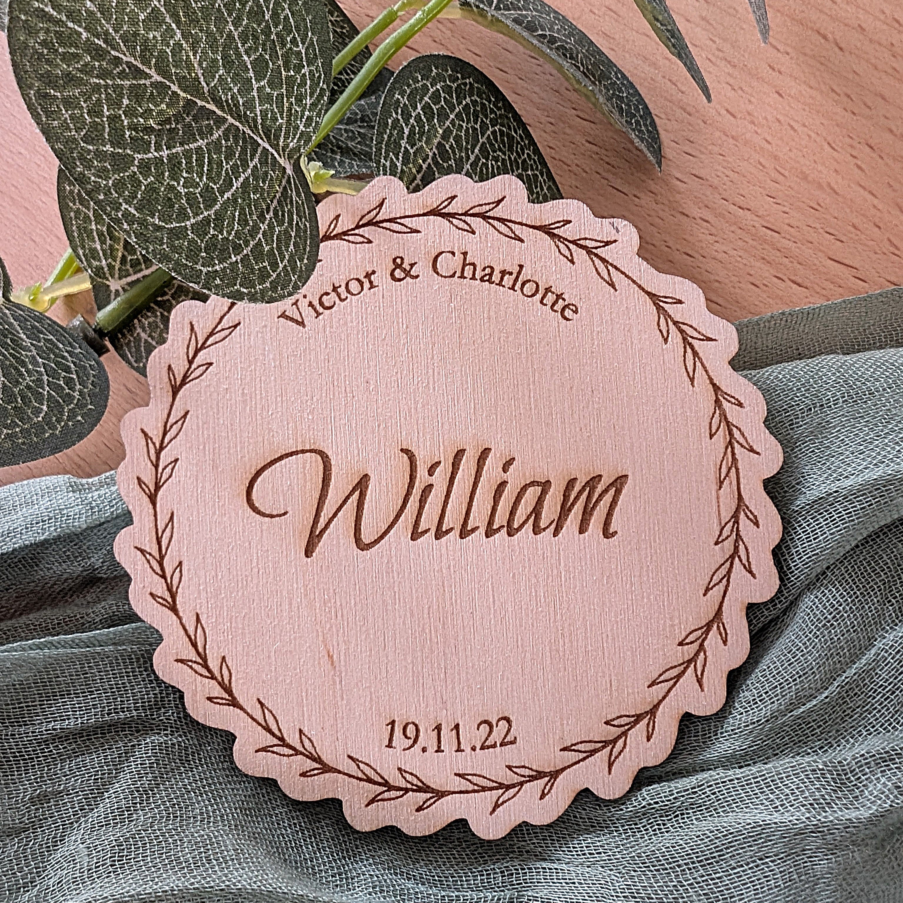Personalized wooden nameplate with engraved text on a soft fabric background