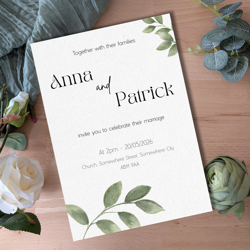 Wedding invitation card for Anna and Patrick with floral decorations on a wooden surface.