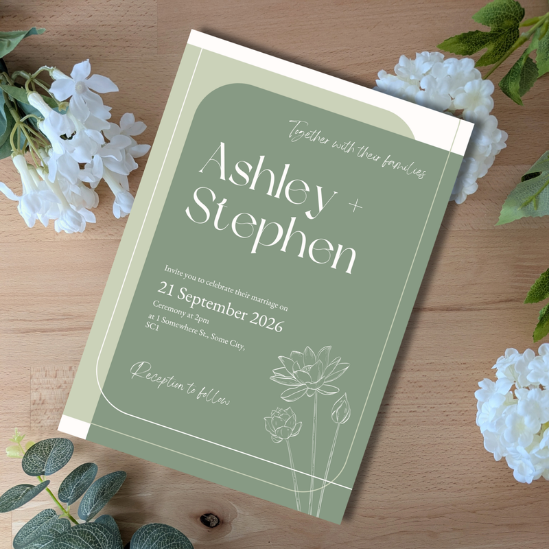 Wedding invitation card for Ashley and Stephen on a wooden surface with flowers.